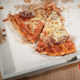 Two slices of pizza left in delivery box